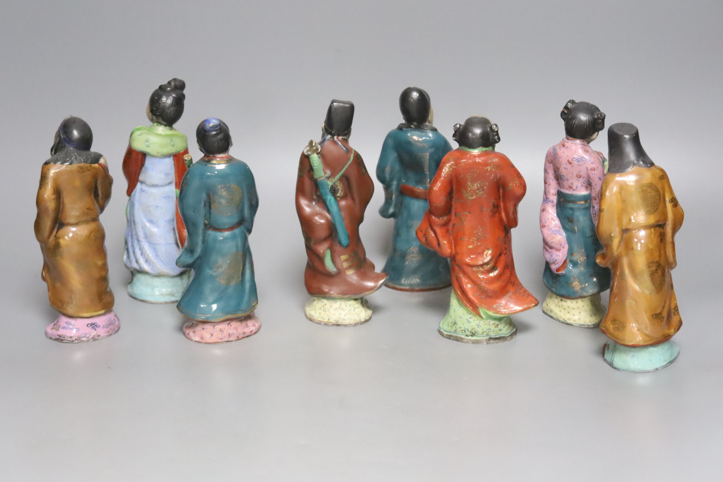 A set of eight 20th century Chinese porcelain figures of immortals, 15cm, each on carved wood stand